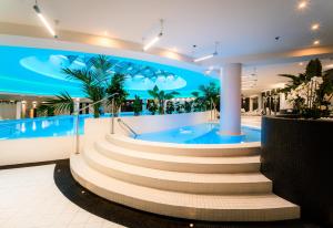 a building with a swimming pool and stairs in it at HANZA Pionier 2 pokoje i balkon SPA & Pool Parking by stayly in Szczecin
