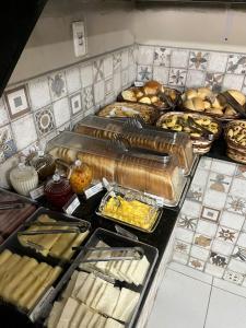 a buffet filled with lots of different types of food at Hotel Prime Ceaka in Caruaru