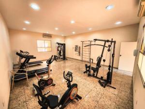 a gym with several exercise bikes and treadmills at Pampulha Flat in Belo Horizonte