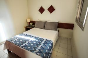 a small bedroom with a bed in a room at Pampulha Flat in Belo Horizonte