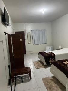 a bedroom with a bed and a television in it at POUSADA ESTRELA DA MANHÃ in Barreirinhas