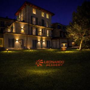 a large building with a yard in front of it at night at Riverwell in Sesto Calende
