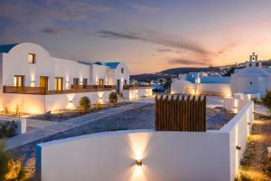 a view of a villa at night with lights at Acro Caldo Suites in Akrotiri