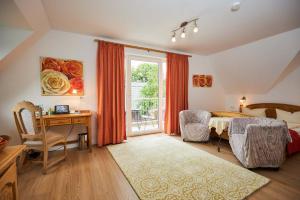 a bedroom with a bed and a desk and a window at Flair-Hotel Neeth in Lehmkuhlen +36 photos