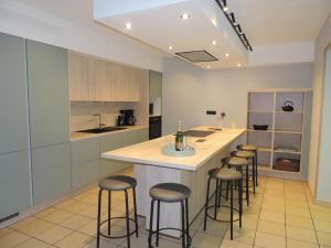 a kitchen with a island with bar stools at Gite 2 de Renuamont in Sainte-Ode