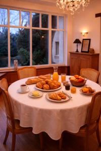 a table with plates of food on it at Le Pré du Dimanche in Maringues