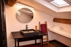 a bathroom with a sink and a mirror at Le Pré du Dimanche in Maringues