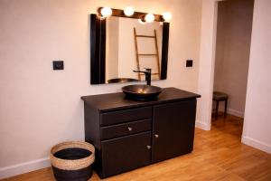 a bathroom with a sink and a mirror at Le Pré du Dimanche in Maringues