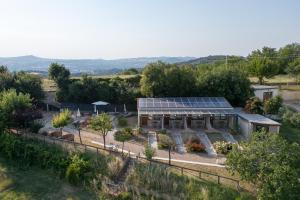 an aerial view of a garden with a greenhouse at Semivaganti Agritur in Candelara