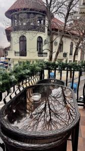 a park bench in front of a building with a water fountain at Hotel Zava Boutique - City Center in Bucharest