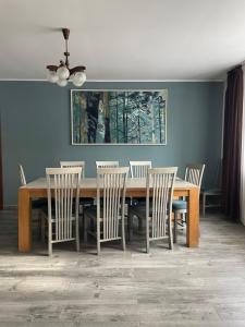 a dining room with a wooden table and chairs at Casa Crăciun in Mănăstirea Humorului