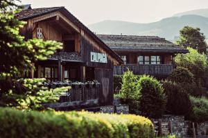 a wooden house with a sign on the front of it at L'Alpaga, a Beaumier hotel in Megève +226 photos