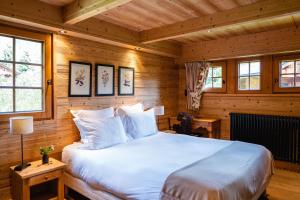 a bedroom with a large bed in a wooden room at L'Alpaga, a Beaumier hotel in Megève