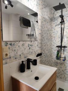 a bathroom with a sink and a mirror at Reyes in Monachil