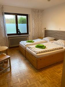 two twin beds in a room with a window at Reiter- und Ferienhof Redder in Bad Driburg