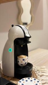 a coffee maker with a cup on a table at Grandstay in Al Hofuf