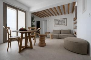 a living room with a table and a couch at REYA suites in Aliki