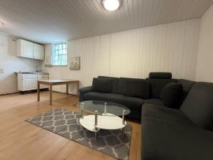 a living room with a couch and a table at Pension Asel in Wörth am Rhein