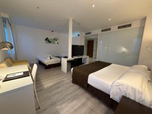 a hotel room with a large bed and a television at Amura Alcobendas in Alcobendas