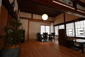 a large living room with a table and chairs at 森ノ間 大谷荘 in Myoko