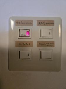 a lightswitch with four different switches on a wall at 森ノ間 大谷荘 in Myoko