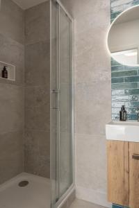 a shower with a glass door in a bathroom at BLI One in Vilsbiburg +9 photos