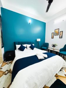 a blue bedroom with a large bed with a blue wall at Nibha Homestay Near Guwahati Railway station 2BHK in Guwahati
