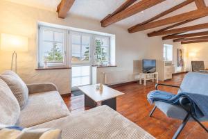 a living room with a couch and a table at Lodge an der Muehle in Bredstedt