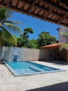 a swimming pool in front of a house at Casa em Prado bahia in Prado