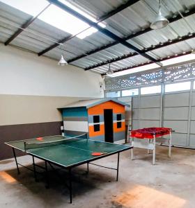 a room with a ping pong table in it at Los Adobes in Cerrillos