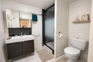 a bathroom with a toilet and a sink and a shower at La Perle de la Baie - Plages à pied & Hyper centre in Pornichet