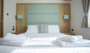 a bedroom with a bed with two towels on it at Bude Holiday Resort by Away Resorts in Bude +58 photos