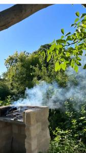 a pile of smoke coming out of a grill at Aguglia Persa - Double Room in Noto