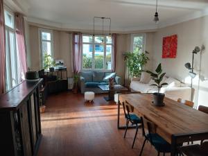 a living room with a table and a couch at La Jarria in Jurançon