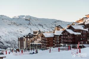 a group of buildings on a ski slope in the snow at D2 Luxury Chalet Mountain View Sleeps 12 Coffee in Val Thorens