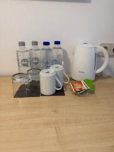 a counter with bottles of water and a coffee maker at Brenzhotel Heidenheim in Heidenheim an der Brenz
