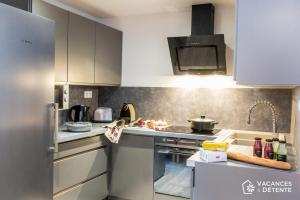 a kitchen with a sink and a stove top oven at D2 Luxury Chalet Mountain View Sleeps 12 Coffee in Val Thorens +15 photos