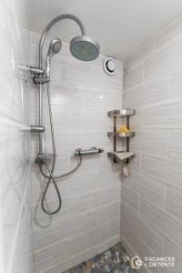 a shower with a shower head in a bathroom at D2 Luxury Chalet Mountain View Sleeps 12 Coffee in Val Thorens