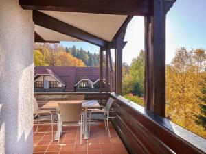 a patio with a table and chairs on a porch at Hapimag Ferienwohnungen Braunlage in Braunlage