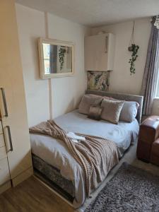 a small bedroom with a bed in the corner at Little Dorrit Studio flat Rochester ME1 1XZ in Strood