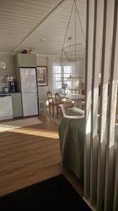 a living room with a kitchen and a dining room at Säbytorp in Kil +20 photos