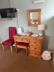 a desk with a lamp and a chair and a mirror at Wentworth arms in Malton