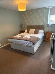 a bedroom with a large bed in a room at Wentworth arms in Malton