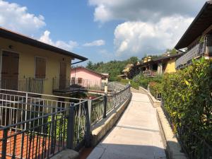 a walkway leading to a building with a fence at Residenz Fontana mit Pool in San Zeno di Montagna