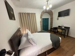 a bedroom with a bed and a table and a desk at Afma Nueva Alta in Cusco +39 photos