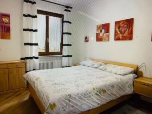 a bedroom with a bed and a window at Residenz Fontana mit Pool in San Zeno di Montagna +21 photos