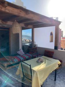 a living room with a couch and a table at Chez Manon & Said in Tamraght Ouzdar