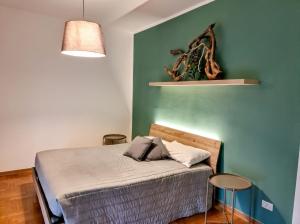 a bedroom with a bed and a green wall at hotel al palazat in Cavasso Nuovo