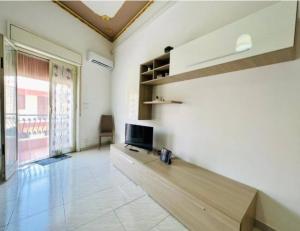 a living room with a tv and a large window at Casa Kennedy in Capaci