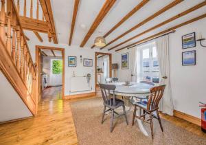 a dining room with a table and chairs at Charming Family Stables Conversion - Pass the Keys in Emsworth
